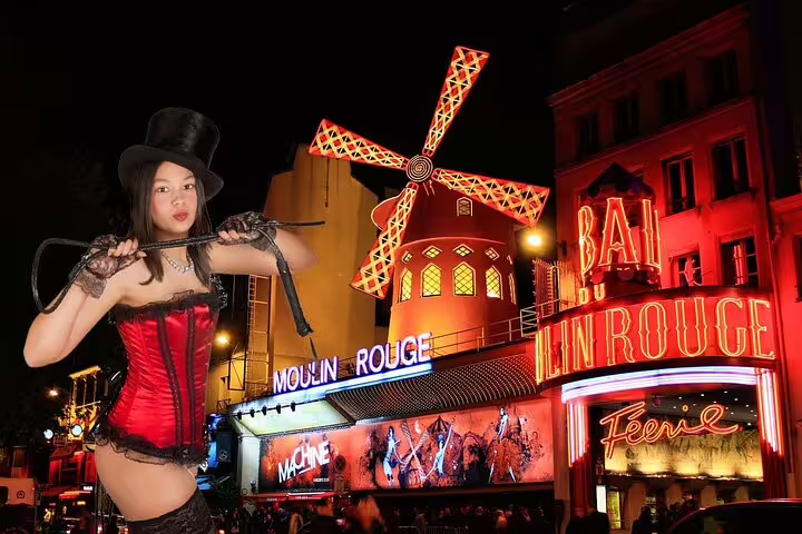 Performer in red corset and top hat posing before the illuminated Moulin Rouge cabaret in Paris at night