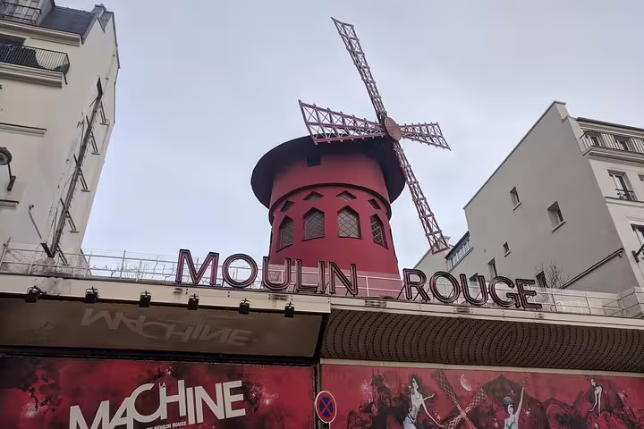 Moulin Rouge windmill and iconic red facade in Montmartre, Paris