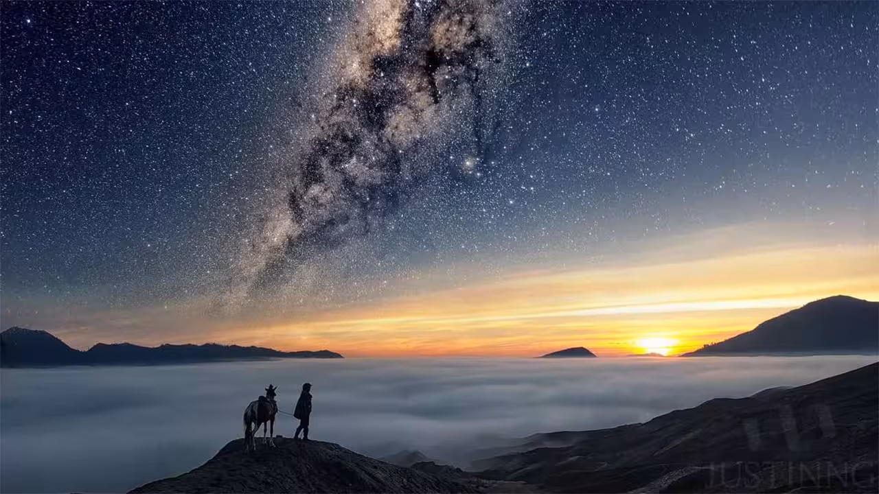 Stunning view of Mount Bromo at sunrise under the Milky Way, perfect for a 2D1N private tour experience.
