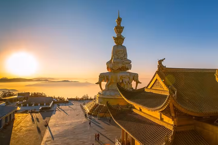 Sunrise view of Mount Emei's Golden Summit with stunning architecture, featured in Chengdu to Leshan tour package.