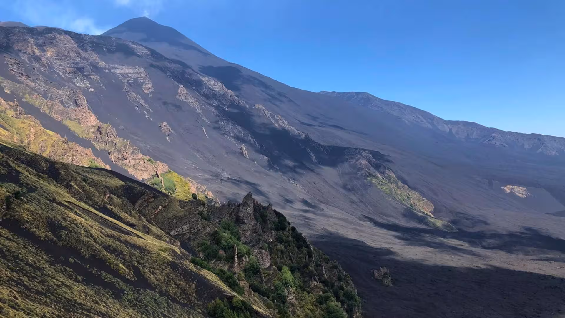 Stunning view of Mount Etna's majestic craters and verdant slopes, showcasing Taormina's remarkable volcanic landscape.