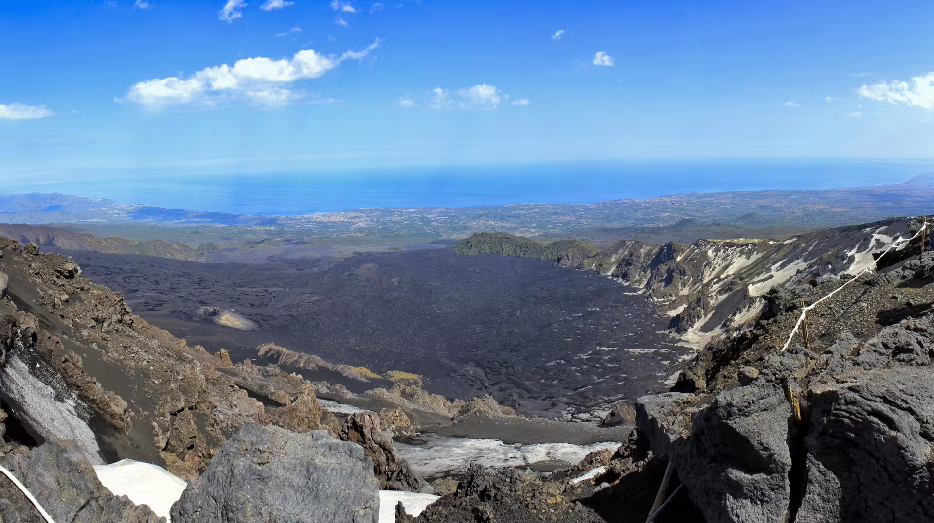 Panoramic view from Mount Etna over lava valley to Ionian Sea, Etna and Taormina tour from Catania