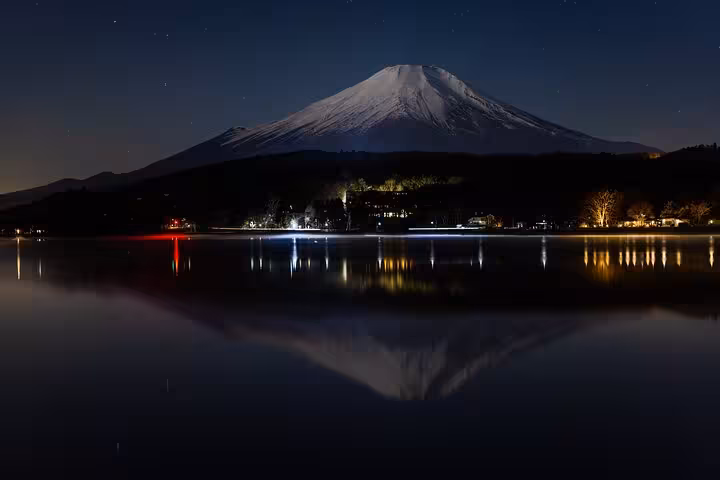 Stunning night view of Mount Fuji reflecting in Lake Ashi, a highlight of the Tokyo to Hakone private guided tour.