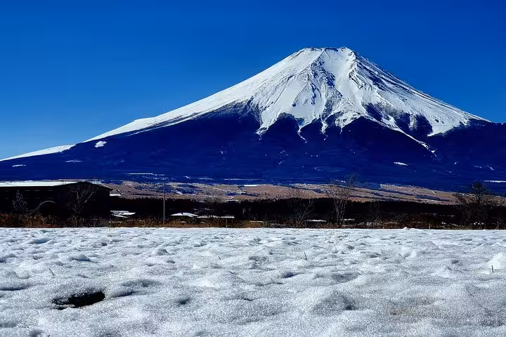 Breathtaking panoramic view of snow-covered Mount Fuji under clear blue sky on a Tokyo Mt Fuji Hakone guided tour