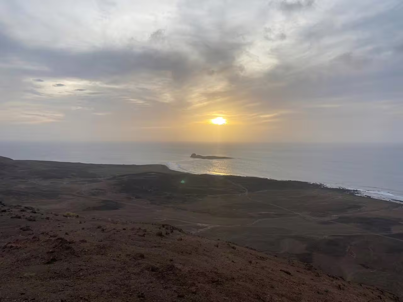 Mount Lion sunset hiking tour with ocean-view lookout, golden sun over the coast and rugged volcanic terrain