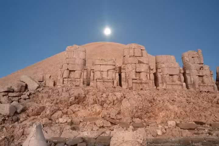 Stone statues on Mount Nemrut in Mesopotamia, Turkey under a bright sky, featured on a private 9-day tour