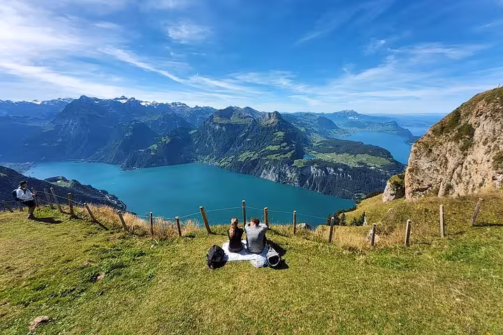 Picnic at Mount Rigi overlooking Lake Lucerne, scenic Zurich day trip with Swiss Alps views and steep funicular