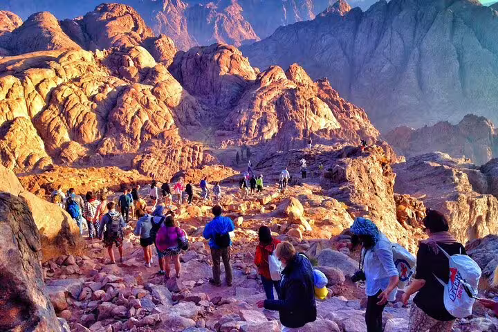 Group hiking Mount Sinai trail at dawn on Sharm El Sheikh tour, combining St Catherine Monastery excursion