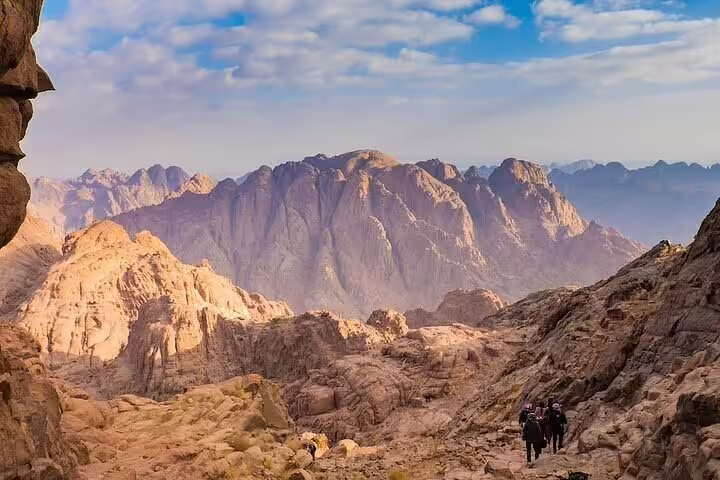 Hikers on Mount Sinai trail near Sharm, rocky desert ridges on private climb to St Catherine Monastery