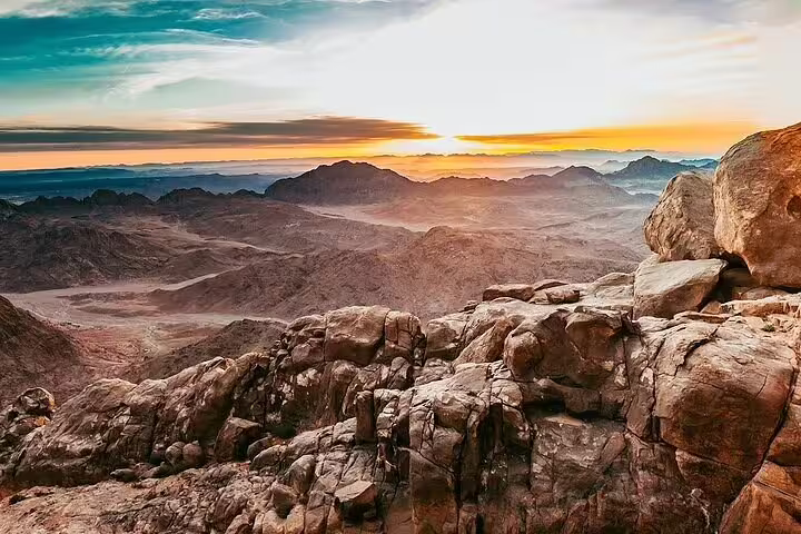 Sunrise view from Mount Sinai summit on private Sharm day tour, rugged Sinai mountains above St Catherine