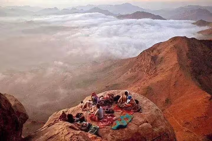 Sunrise view above clouds at Mount Sinai summit on Sharm El Sheikh hike with St Catherine Monastery visit