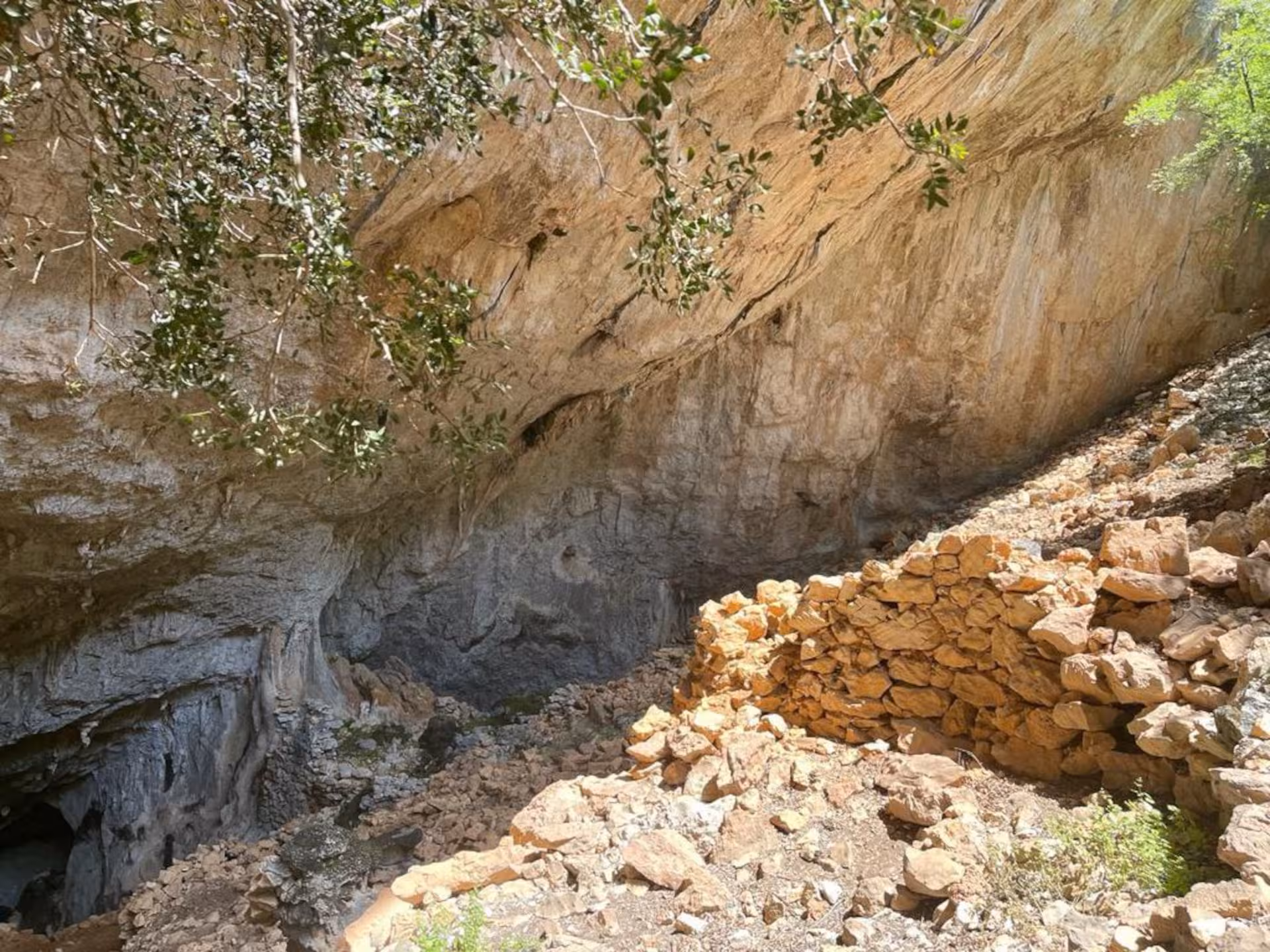 Explore the ancient stone ruins and rugged cave formations of Mount Tiscali on a scenic trekking tour from Oliena.