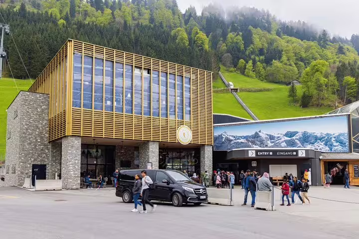 Entrance to the Mount Titlis cable car station in Engelberg, bustling with visitors ready for alpine adventures.