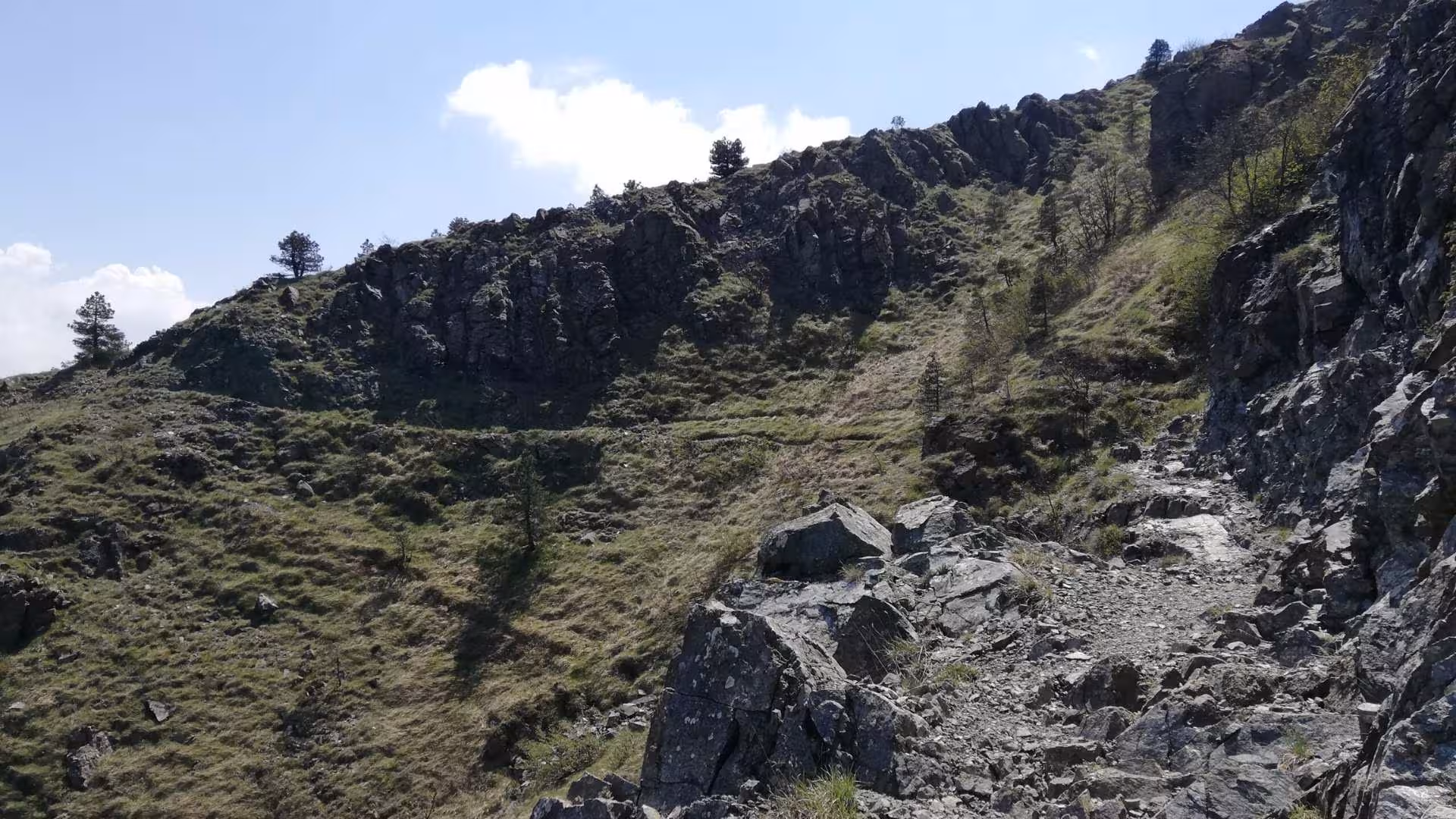 Rocky hiking trail on Mount Tobbio in Capanne di Marcarolo Park, offering scenic views and challenging terrain.