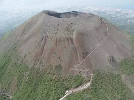 Aerial view of Mount Vesuvius crater and hiking trail, a highlight of private day tours from Positano to Pompei Vesuvio