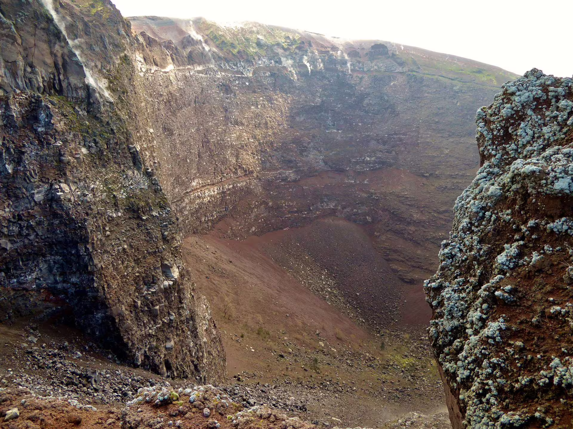 Mount Vesuvius crater viewpoint on a low cost tour from Naples, with steaming rim and volcanic rock walls