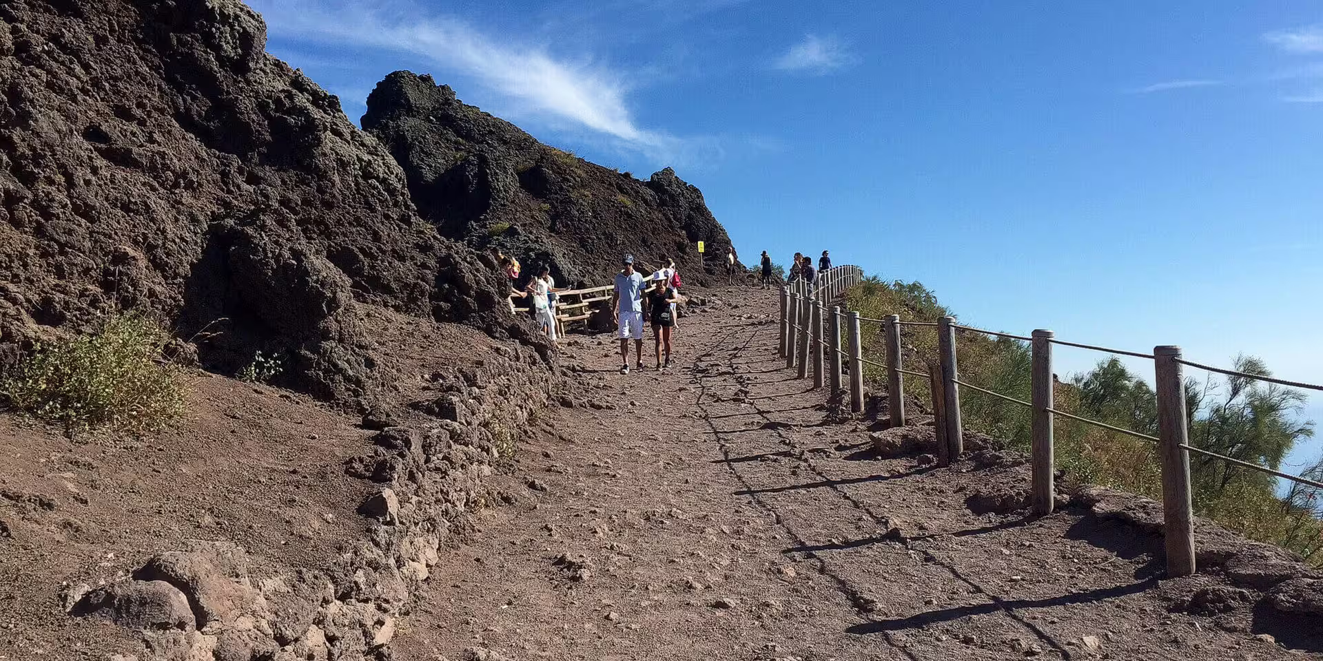 Hikers on Mount Vesuvius crater trail, low cost Vesuvius tour from Naples with panoramic views