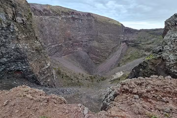 View inside the crater of Mount Vesuvius, showcasing its geological features as part of the guided tour experience.