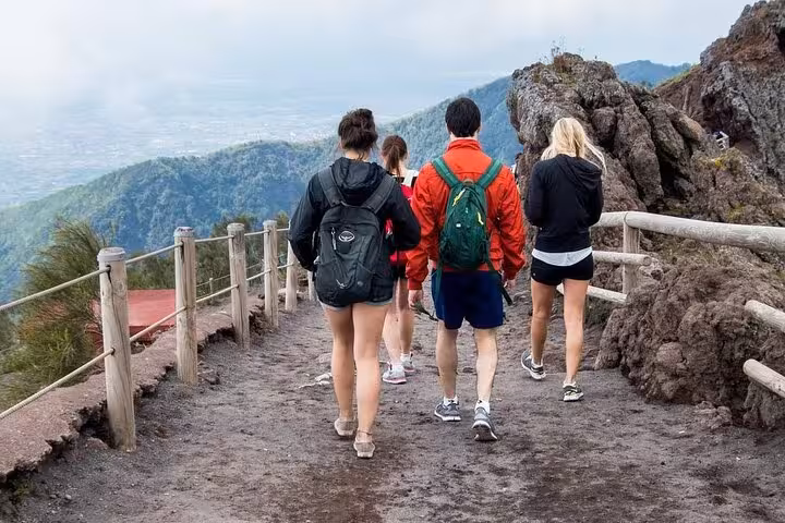 Tourists hiking the scenic trail on Mount Vesuvius, enjoying panoramic views on a skip-the-line Pompeii tour.