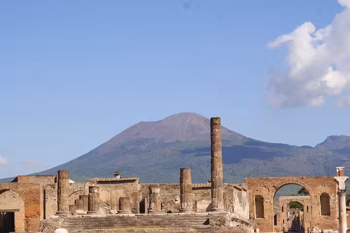 View of Mount Vesuvius overlooking Pompeii ruins, a key highlight of the full-day tour with lunch included.