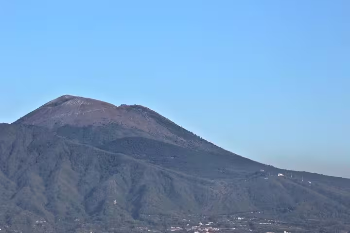 Close-up view of Mount Vesuvius volcano slopes under clear sky, affordable Vesuvius tour from Naples