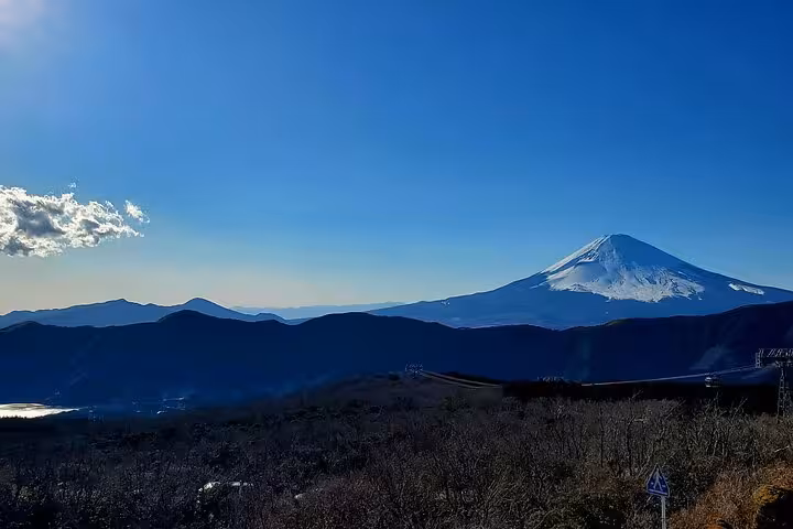 Stunning panoramic view of snow-capped Mt Fuji rising above Hakone mountains on a 2-day guided Japan tour