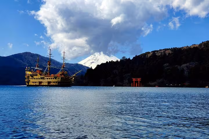 Pirate ship sails on Lake Ashi with Mt. Fuji in the background, showcasing a scenic Hakone tour experience.