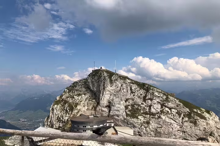 Panoramic view of Mt. Pilatus peak with a picturesque backdrop of clouds, ideal for a Basel small group tour experience.