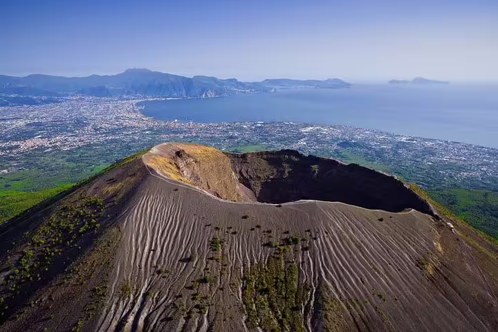 Aerial view of Mt Vesuvius crater above Naples Bay on a guided private day trip combining Pompeii, Herculaneum and winery visit