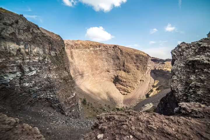 Breathtaking view of Mt. Vesuvius crater under a clear blue sky, highlighting its volcanic landscape from Naples tour.