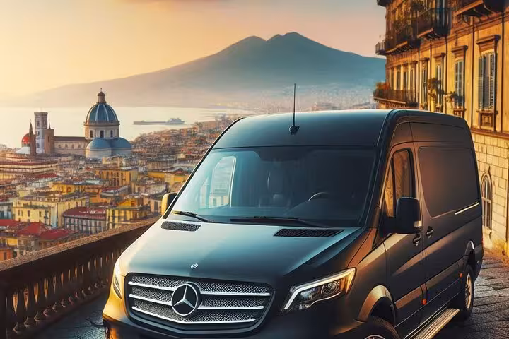 Luxurious van ready for a private tour of Mt. Vesuvius, Pompeii, and Sorrento with stunning views of Naples at sunset.
