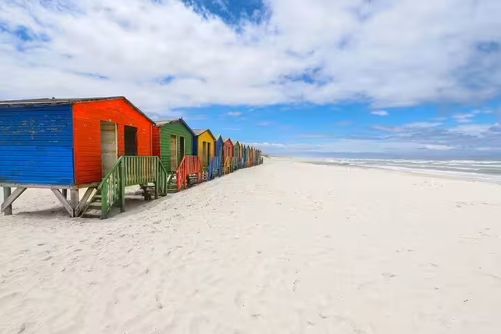 Colorful Muizenberg beach huts on Cape Town Cape Peninsula full-day tour with ocean views and white sand
