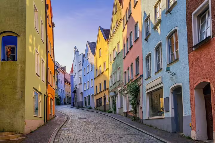 Colorful historic buildings lining a cobblestone street in Munich's old town