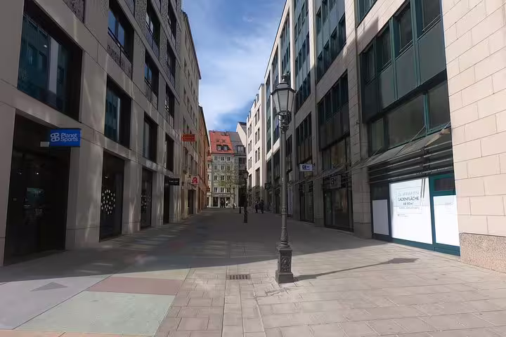 Empty pedestrian street in Munich with historic buildings and a vintage street lamp