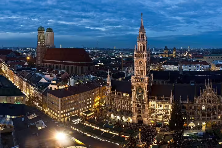 Aerial twilight view of Munich's Marienplatz with New Town Hall clock tower and Frauenkirche cathedral