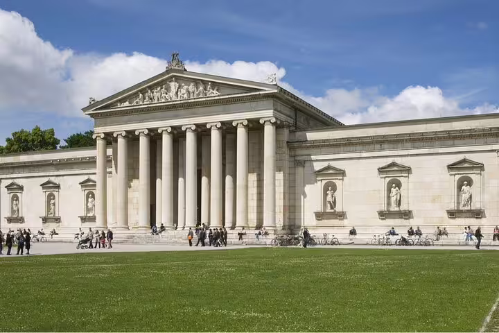 Glyptothek neoclassical museum with columns on Königsplatz Munich, visitors on lawn