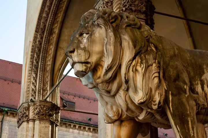 Golden lion statue at ornate Munich Old Town building entrance