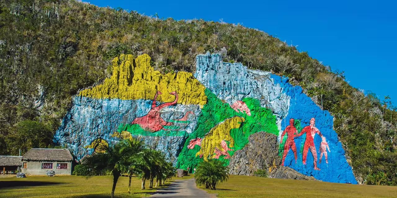 Mural de la Prehistoria in Viñales, Cuba, on Pinar del Río to Havana cultural tour with iconic limestone cliff art