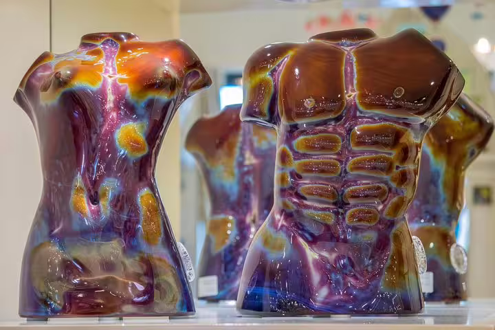 Colorful Murano glass sculptures on display, showcasing intricate craftsmanship on a Venice and Murano tour.