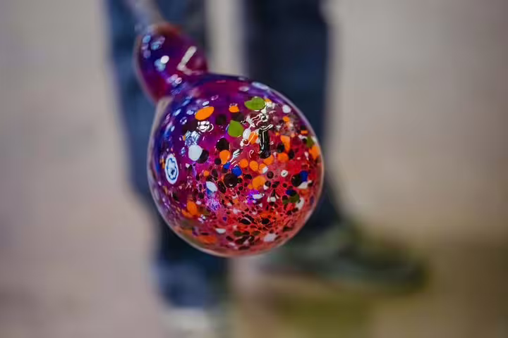 Close-up of colorful, hand-blown Murano glass sphere, featuring intricate craftsmanship on the Murano boat tour.