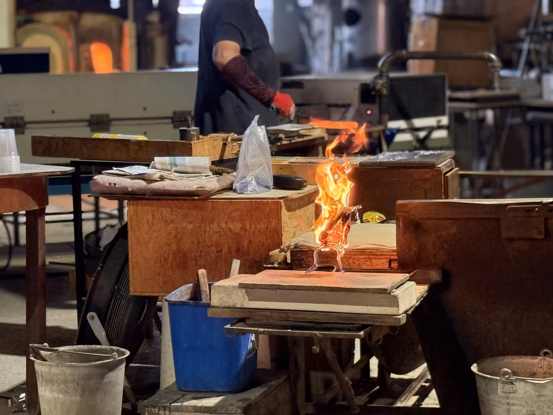 Glassmaker working in a Murano studio, crafting unique pieces with traditional techniques during exclusive tour.