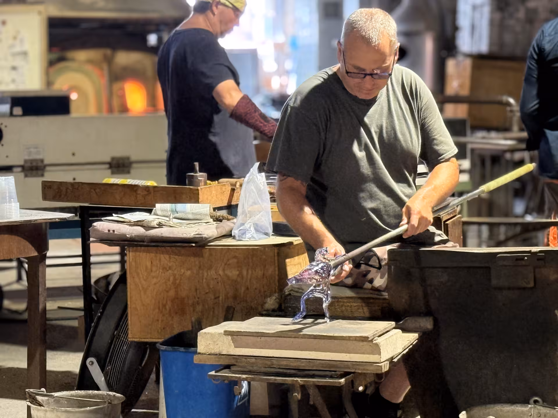 Artisan crafting glass sculpture during Murano Island glassblowing demonstration on exclusive private excursion.