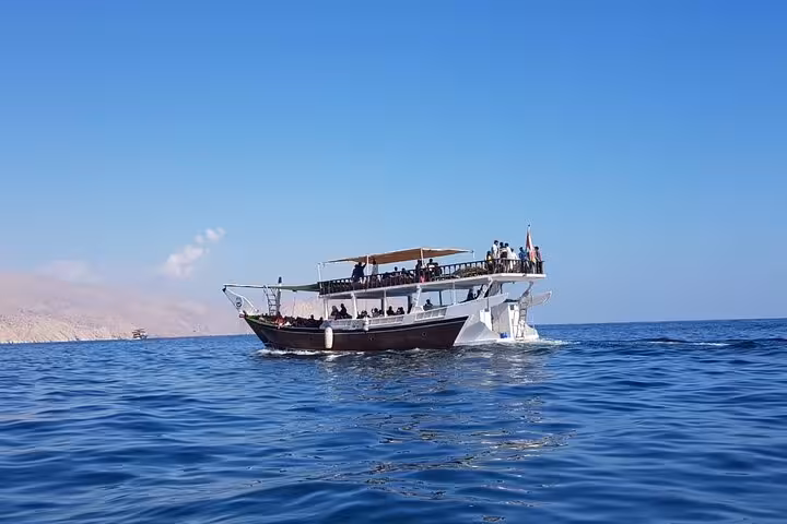Musandam dhow cruise in Oman waters, full-day boat trip for fishing, snorkeling, and buffet lunch onboard