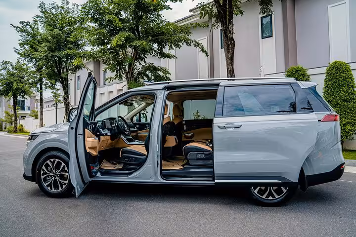 Spacious modern minivan with open doors ready for a comfortable Muscat to Dubai private transfer service