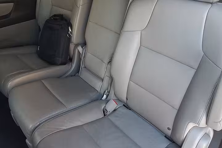 Spacious leather rear seats with seatbelts in a private transfer vehicle for Muscat to Nizwa trip up to 4 pax