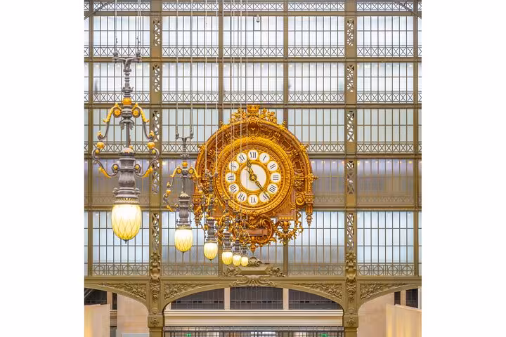 Ornate golden clock inside Musée d’Orsay, entry included with Full Day Paris City Pass for 50 museums