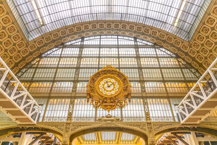 Ornate golden clock inside Musée d'Orsay in Paris, included with skip-the-line tickets on a private Seine walking tour