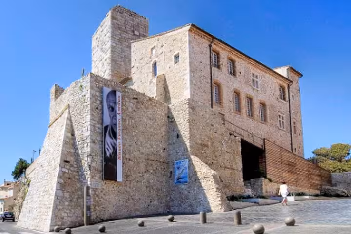 Musée Picasso in Antibes, a historic stone castle fortress on the French Riviera under clear blue sky