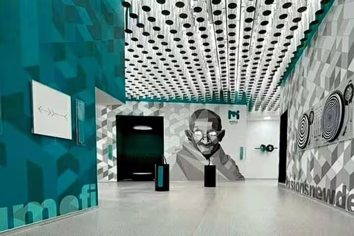 Colorful geometric interior of Museum of Illusions Paris with large portrait mural and optical art installations