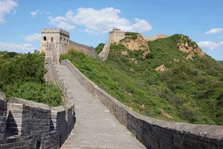 Mutianyu Great Wall under a clear blue sky, ideal for a private tour with an English-speaking driver.